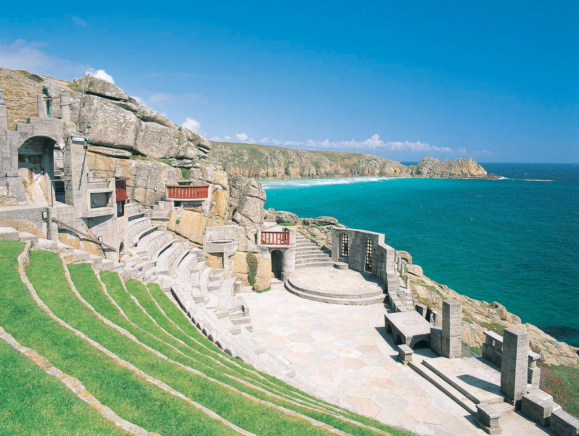 The Minack Theatre carved into cliffs above a turquoise sea in Cornwall