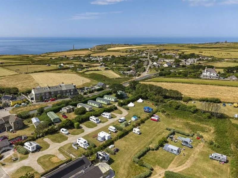Aerial view of Trevaylor Caravan and Camping Park pitches with caravans, motorhomes and bell tents near the coast