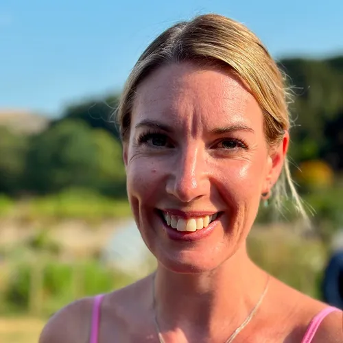 Portrait of dancer Aimee Miller smiling outdoors in warm evening sunlight