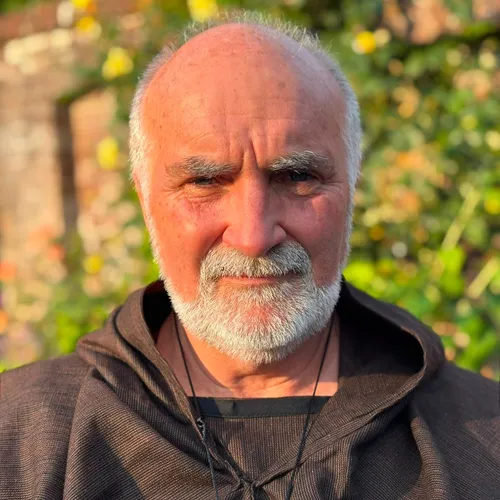 Portrait of Steve Jenner as Friar Lawrence in a brown monk's robe outdoors