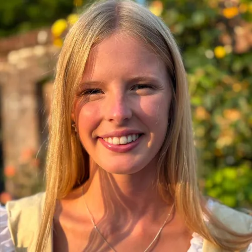 Portrait of Juliet Edie Grower smiling outdoors in warm evening sunlight