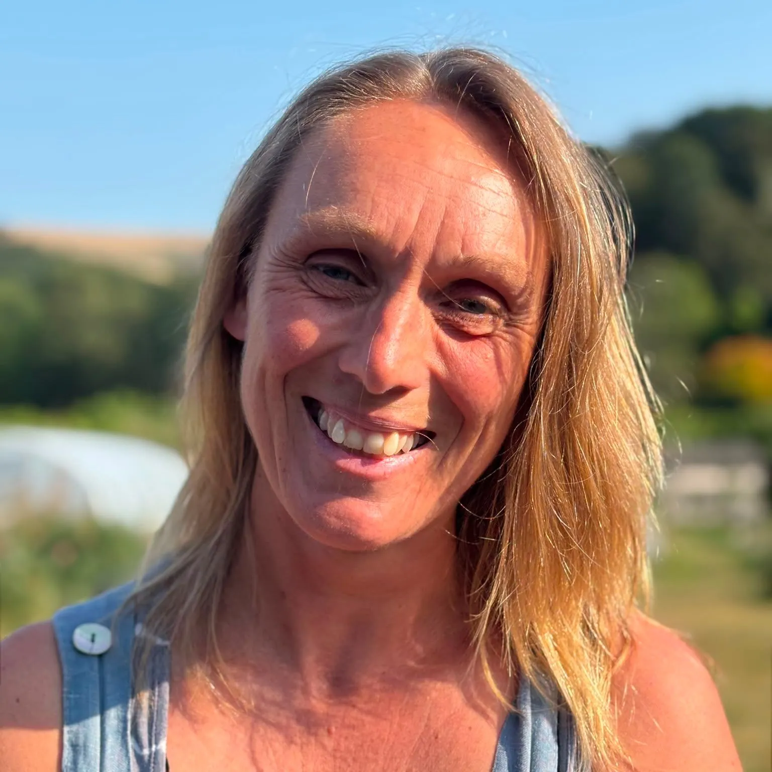Portrait of Zoe Perkins smiling outdoors in warm evening sunlight